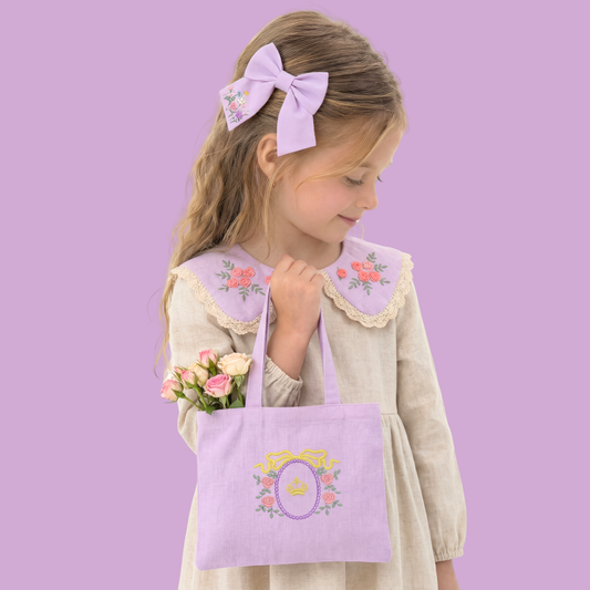 Coordinated lilac linen set with embroidered collar, bow, and shopper bag